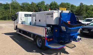 A line pump truck on hire is standing in a parking lot