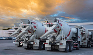 Readymix Concrete trucks standing in a line ready to be loaded with concrete